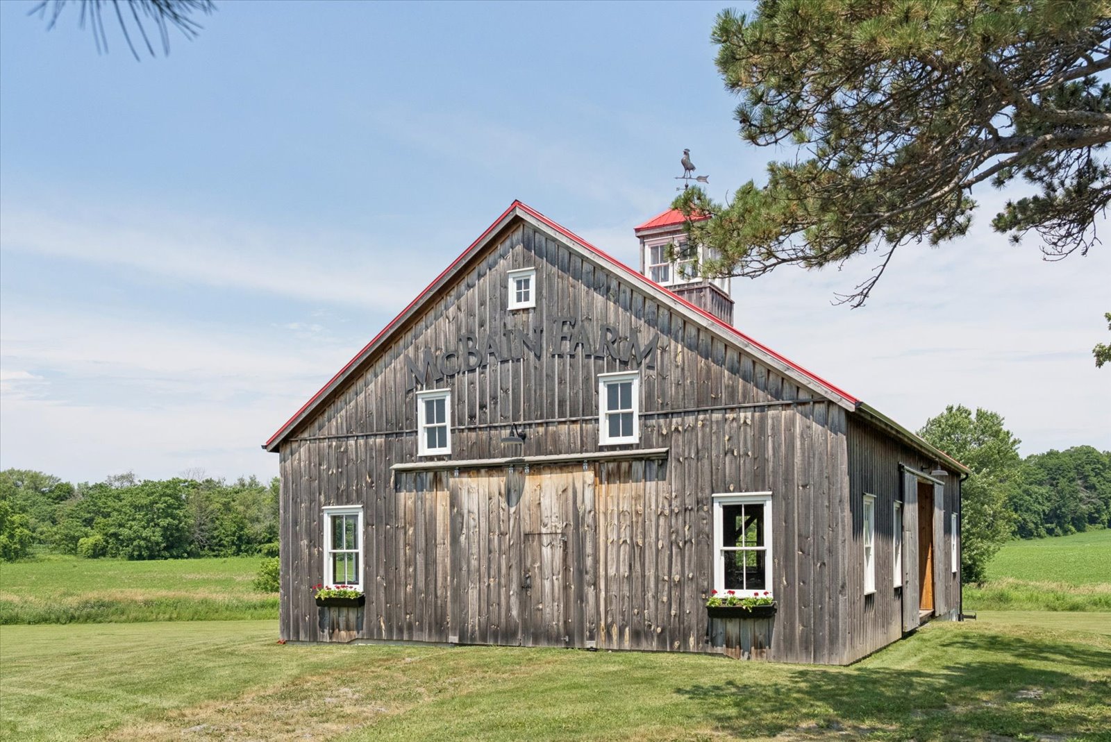 McBain Farm lettering on the barn gable with cupola above