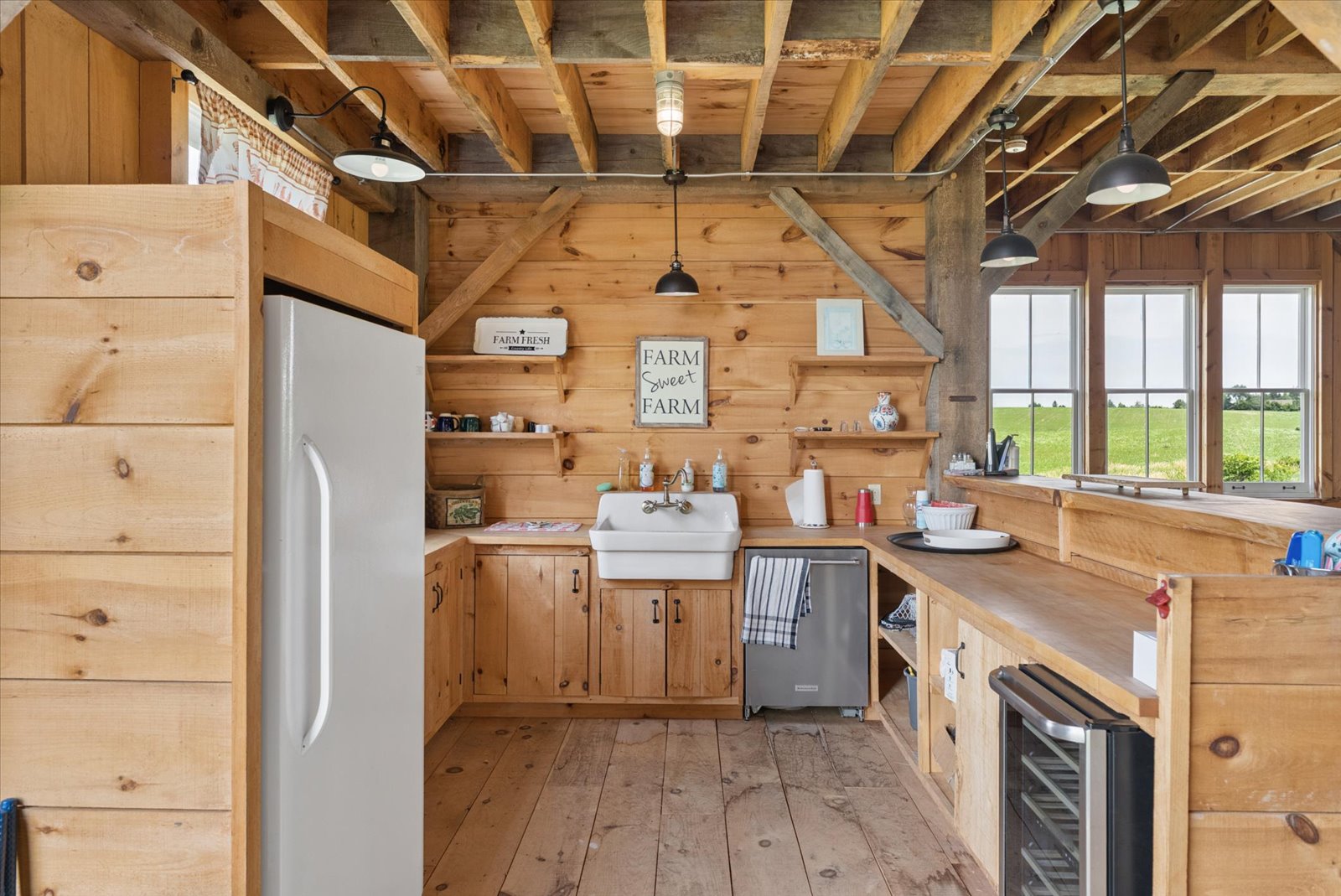 Barn kitchen with farmhouse sink and windows over the fields