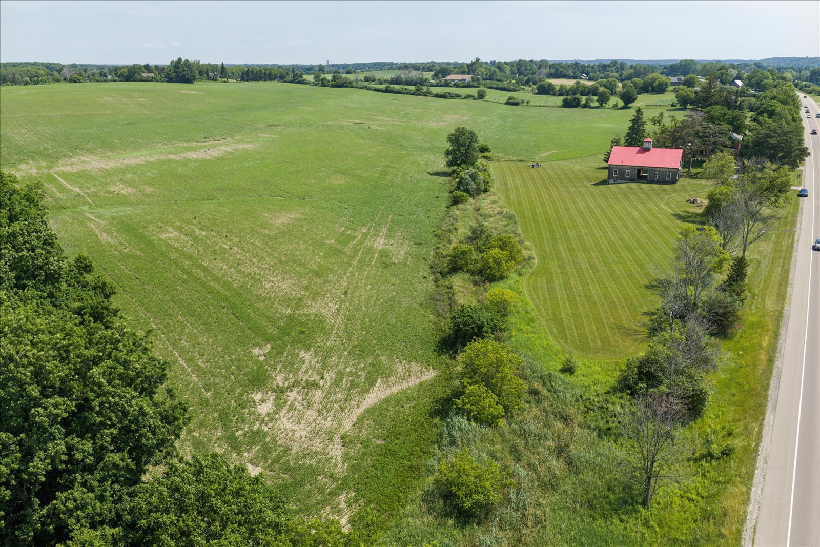 Tile-drained fields sweeping back from the barn