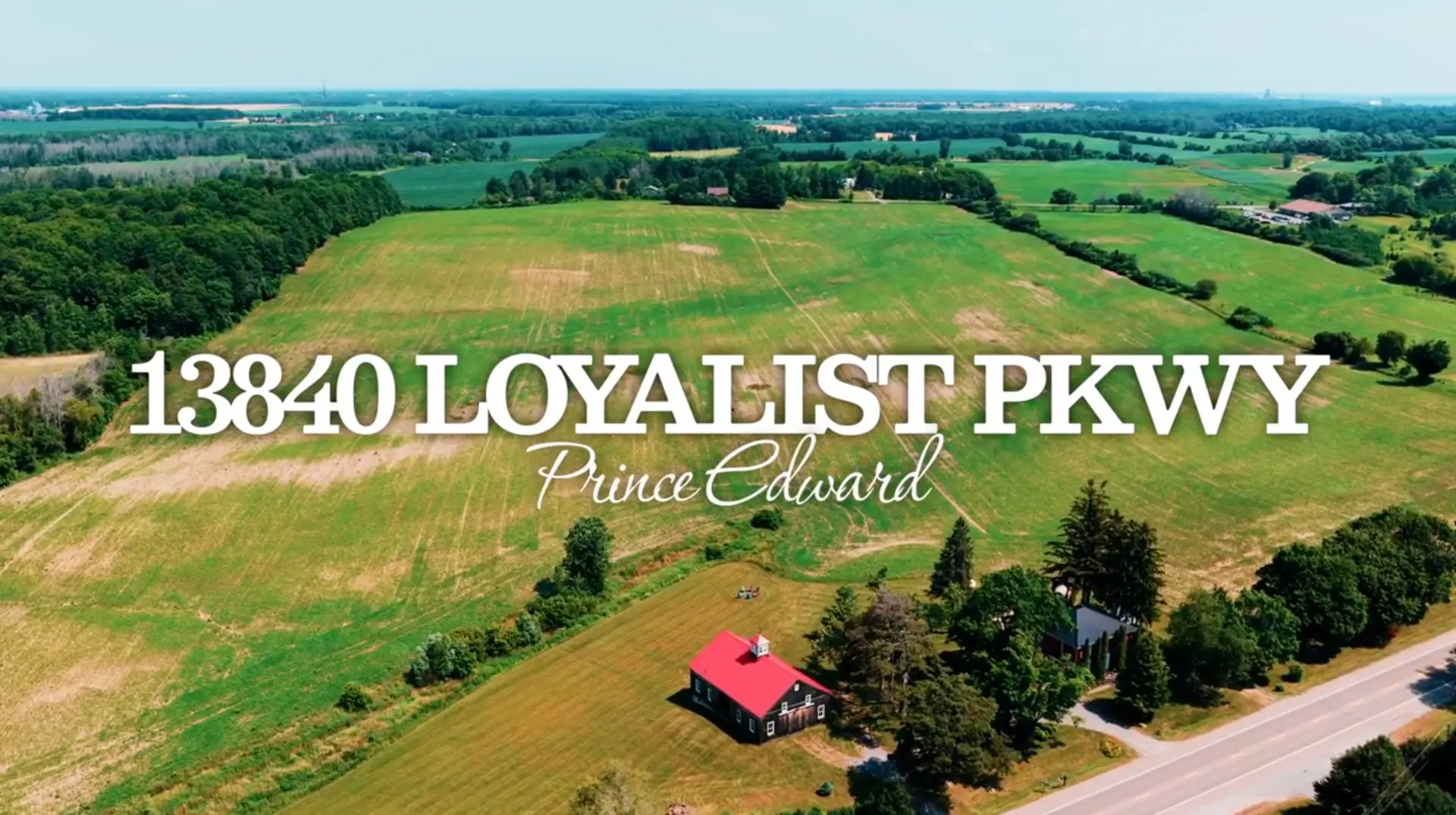 Aerial view over the fields, barn and farmhouse at 13840 Loyalist Parkway