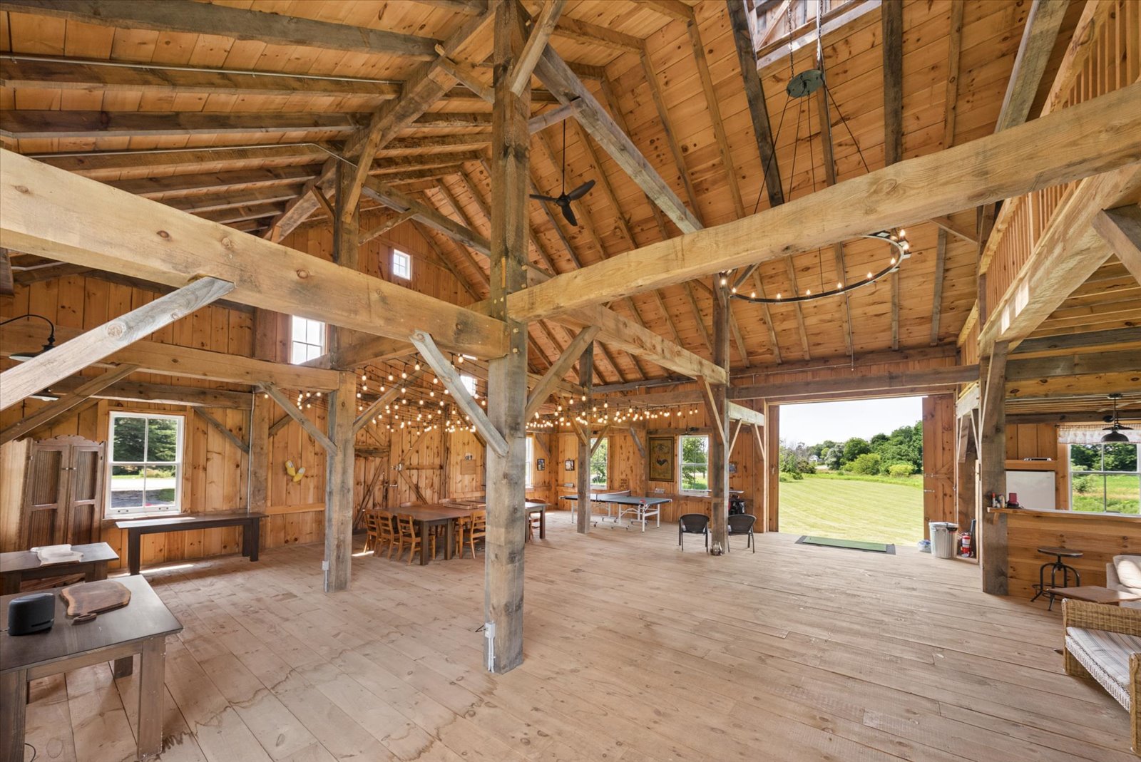 Open barn bay with hand-hewn posts and wide plank floors
