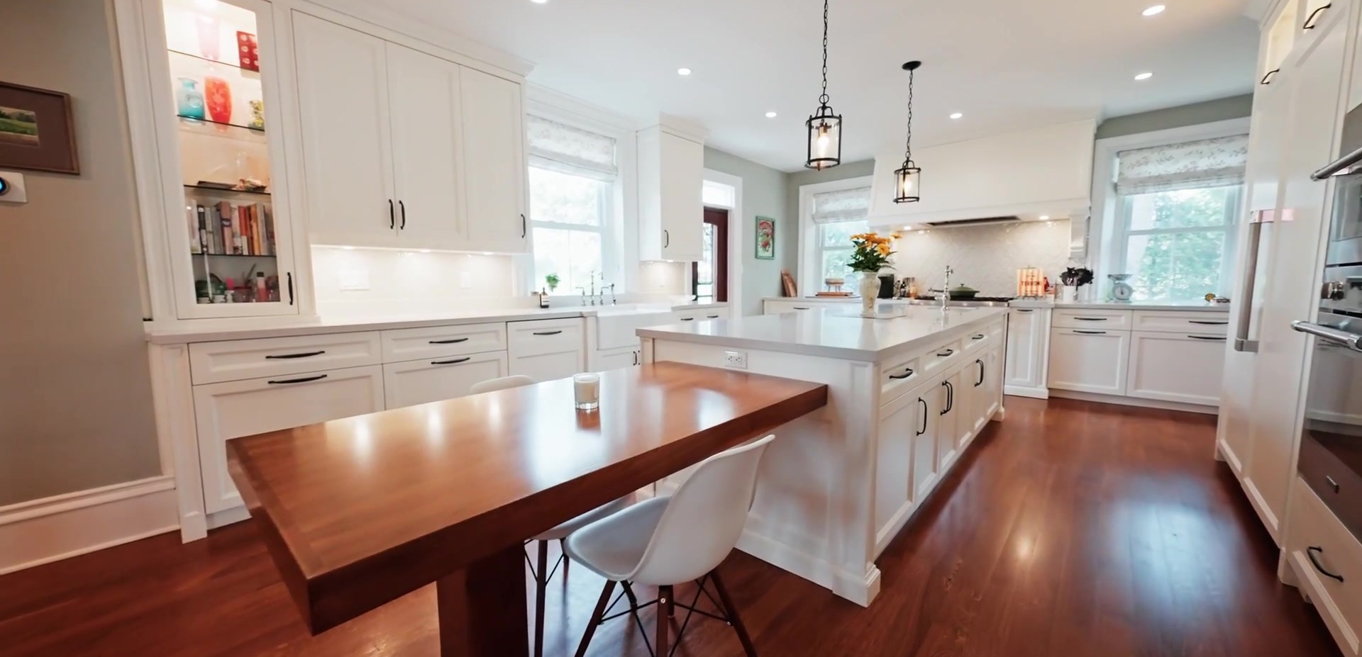 Kitchen with white cabinetry and a large island