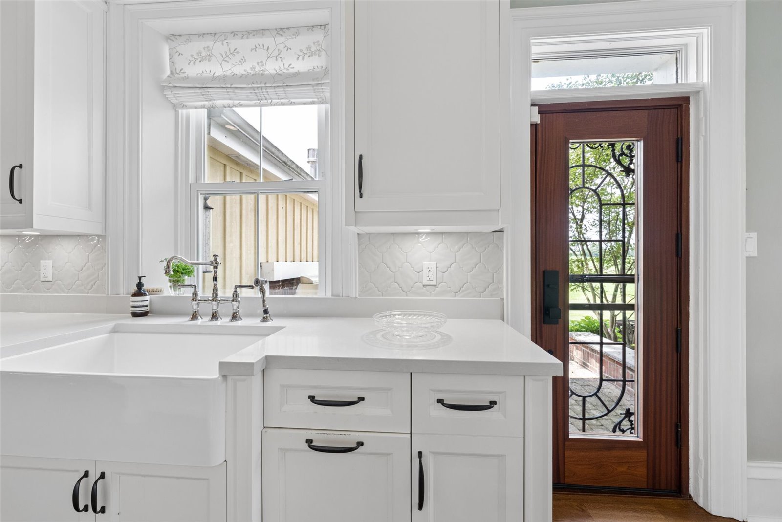Farmhouse sink beneath the window with view to the barn
