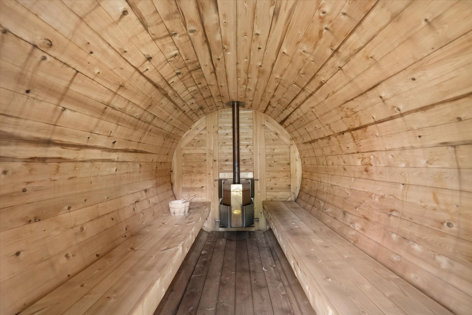 Inside the barrel sauna with wood-fired stove