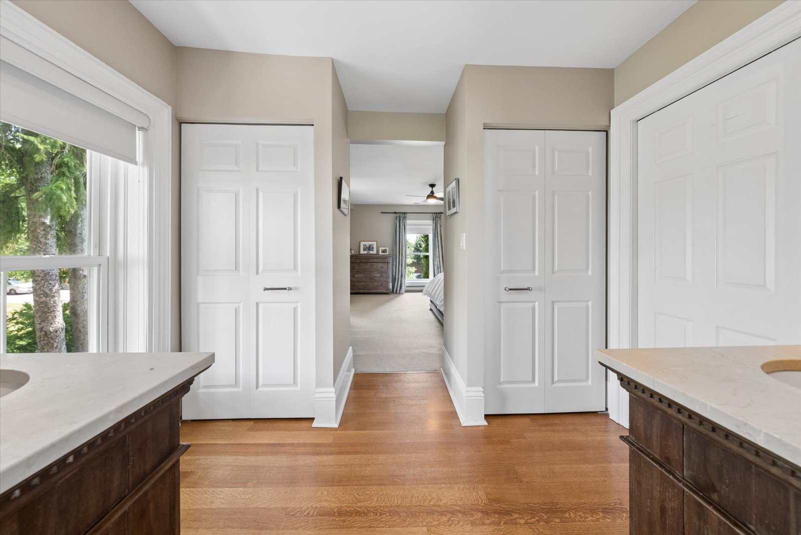 Dressing passage with double closets between suite and bath