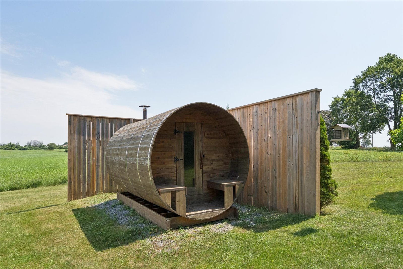 Cedar barrel sauna with privacy screen