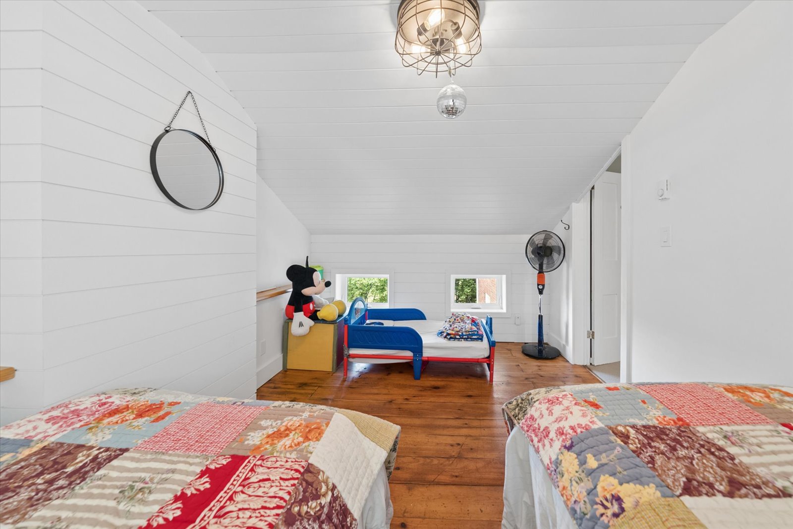 Bunk room under the eaves with dormer windows