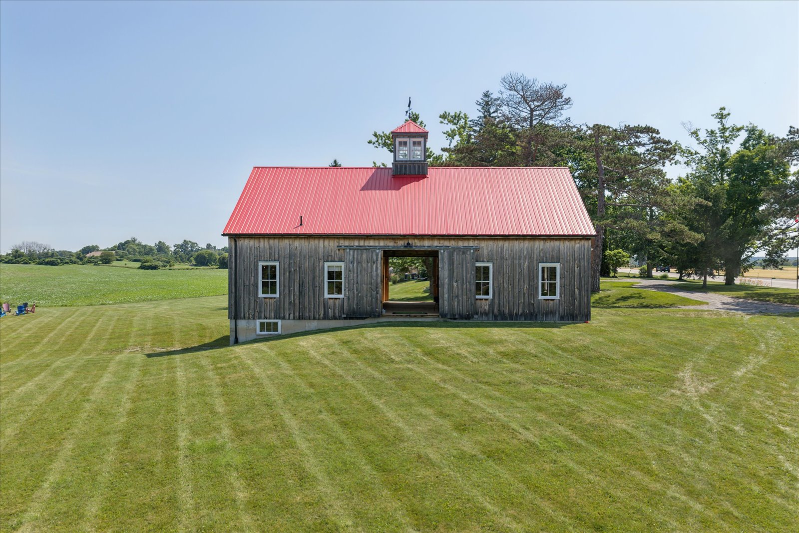 Barn front with open drive doors and cupola above