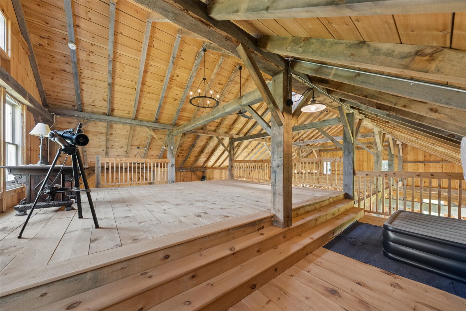 Raised loft platform under the barn's original trusses