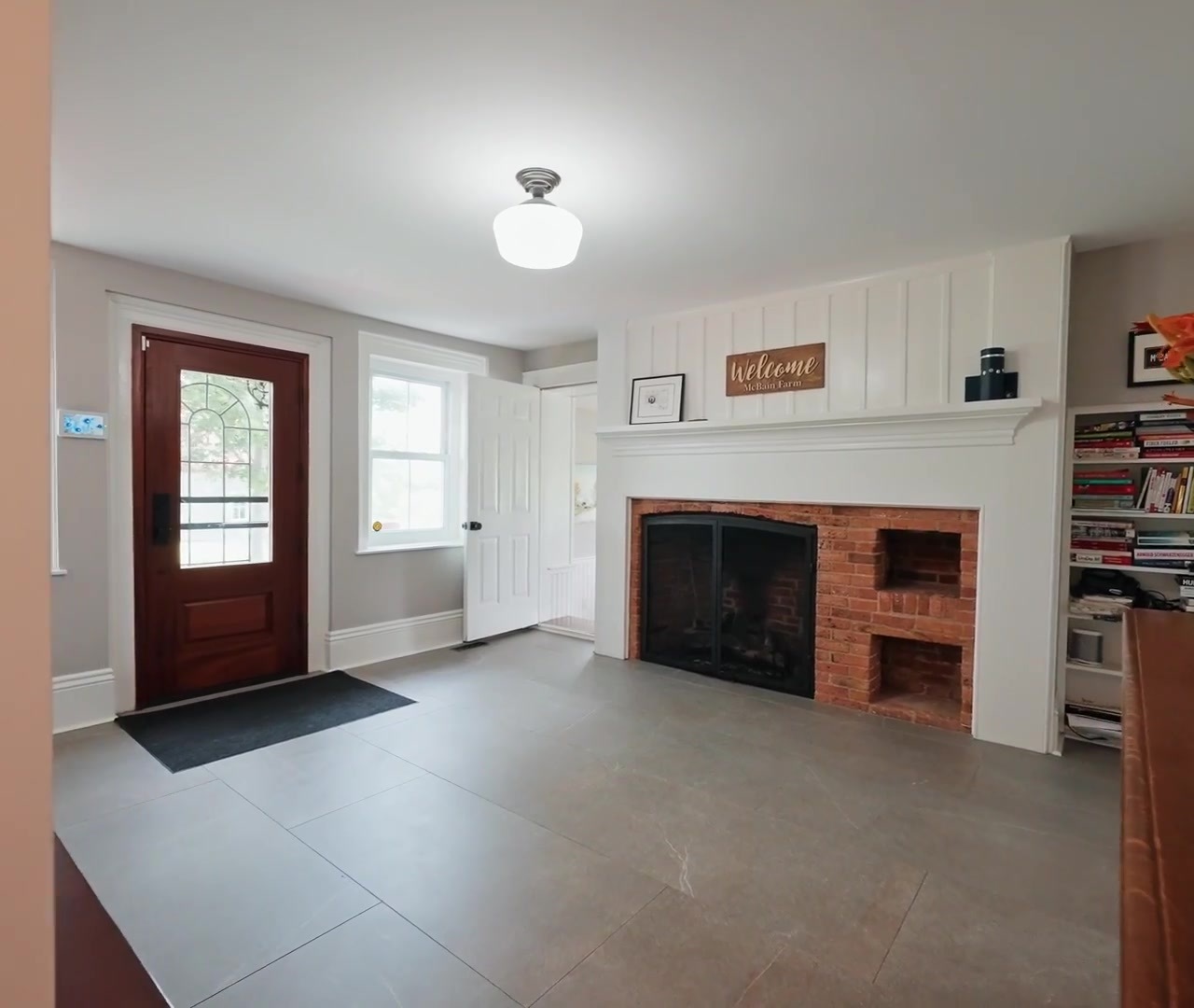 Entryway with fireplace and red door