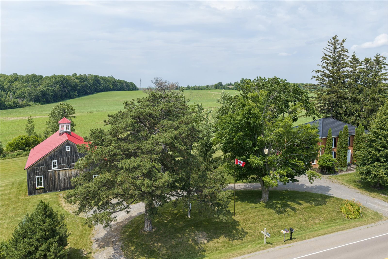 Aerial view of the farmhouse, Dutch-style barn and rolling fields