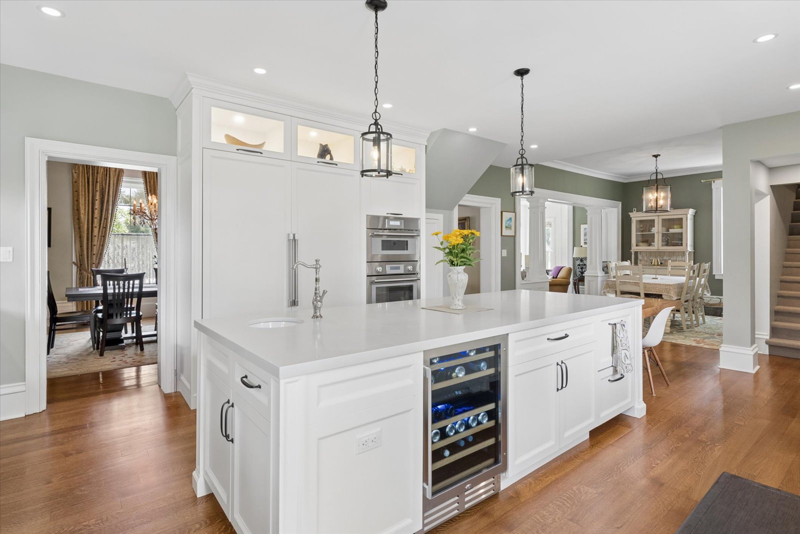 Island with wine fridge, double ovens and dining beyond