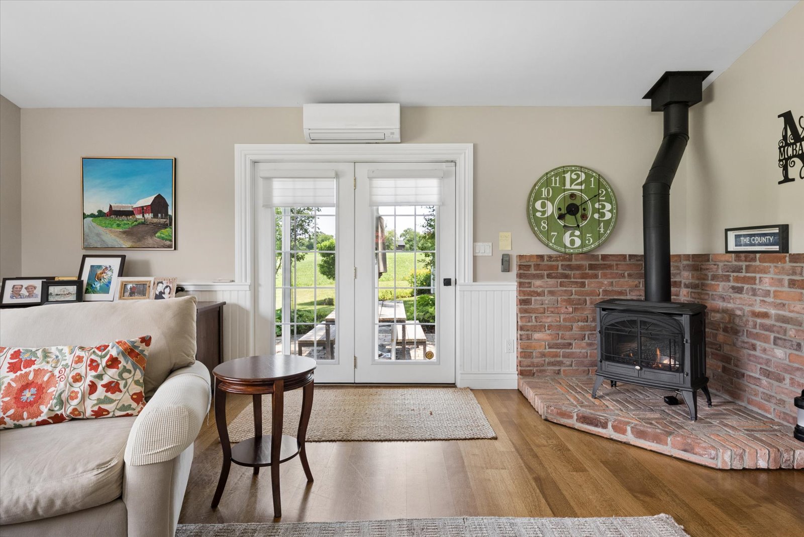 Family room woodstove on a brick hearth beside garden doors