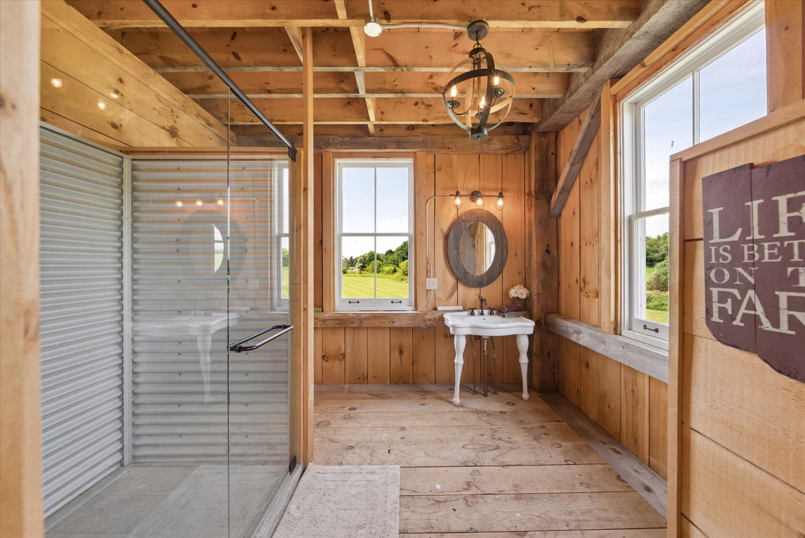Barn shower room with corrugated surround and field views