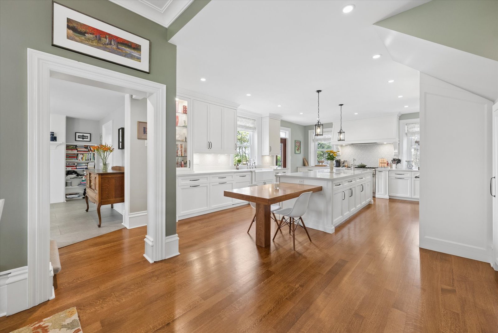 Open kitchen with walnut table and butler's pantry beyond