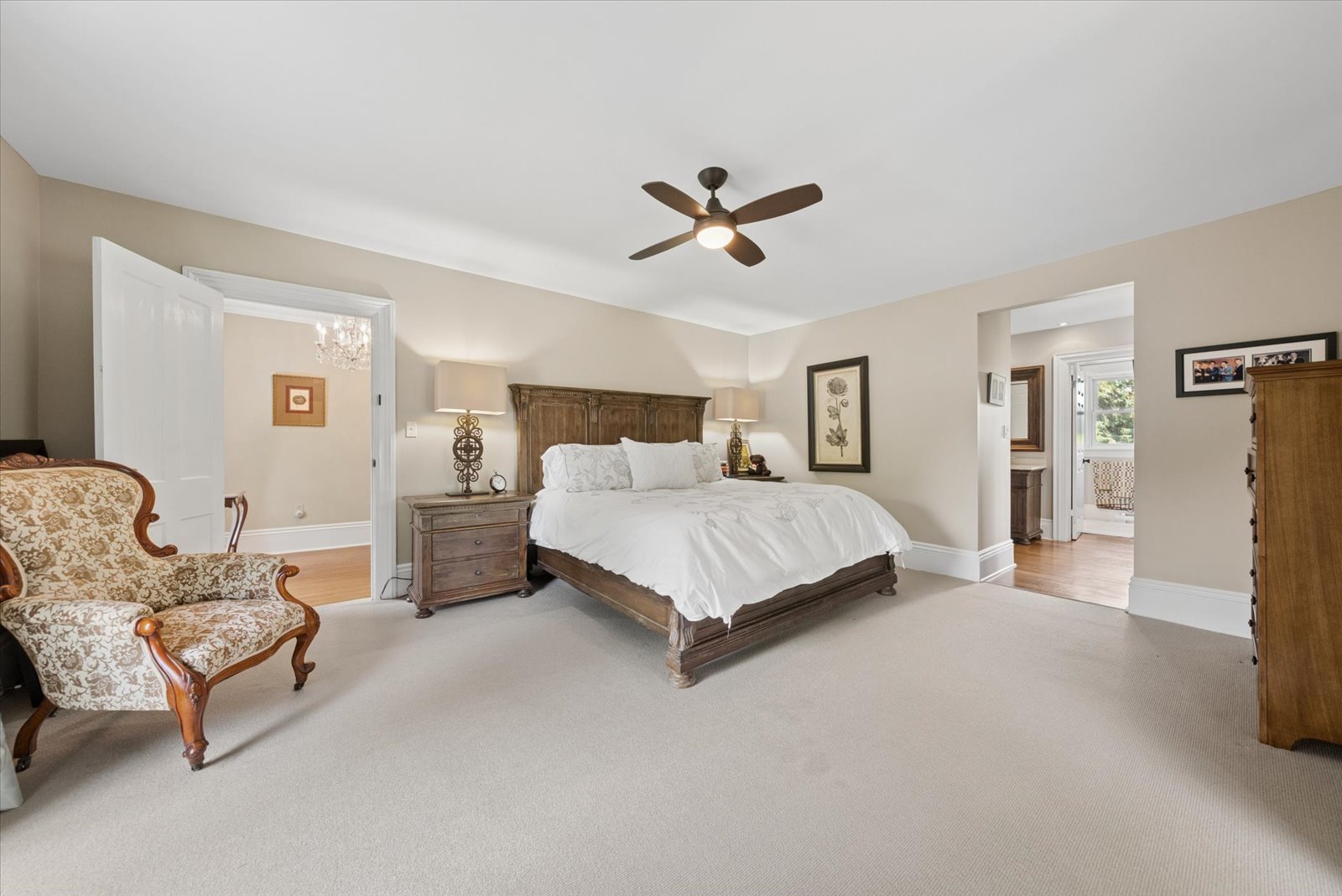 Spacious principal suite with carved wood bed