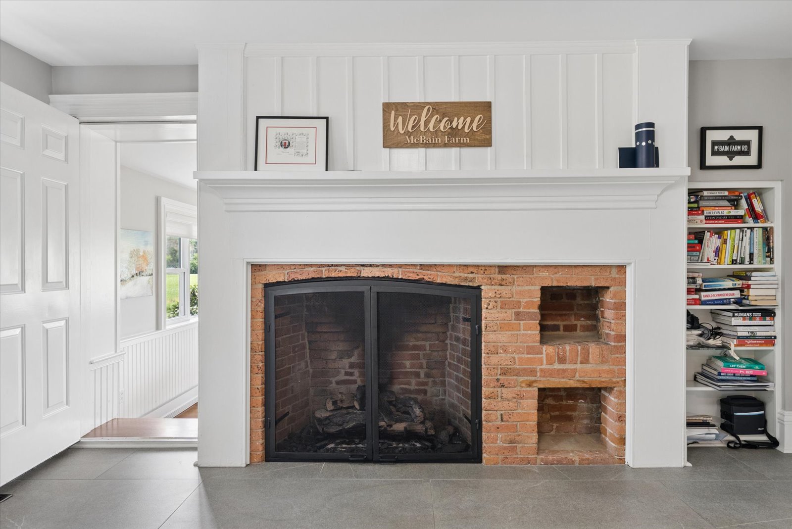 Board-and-batten fireplace with original brick firebox and bake oven