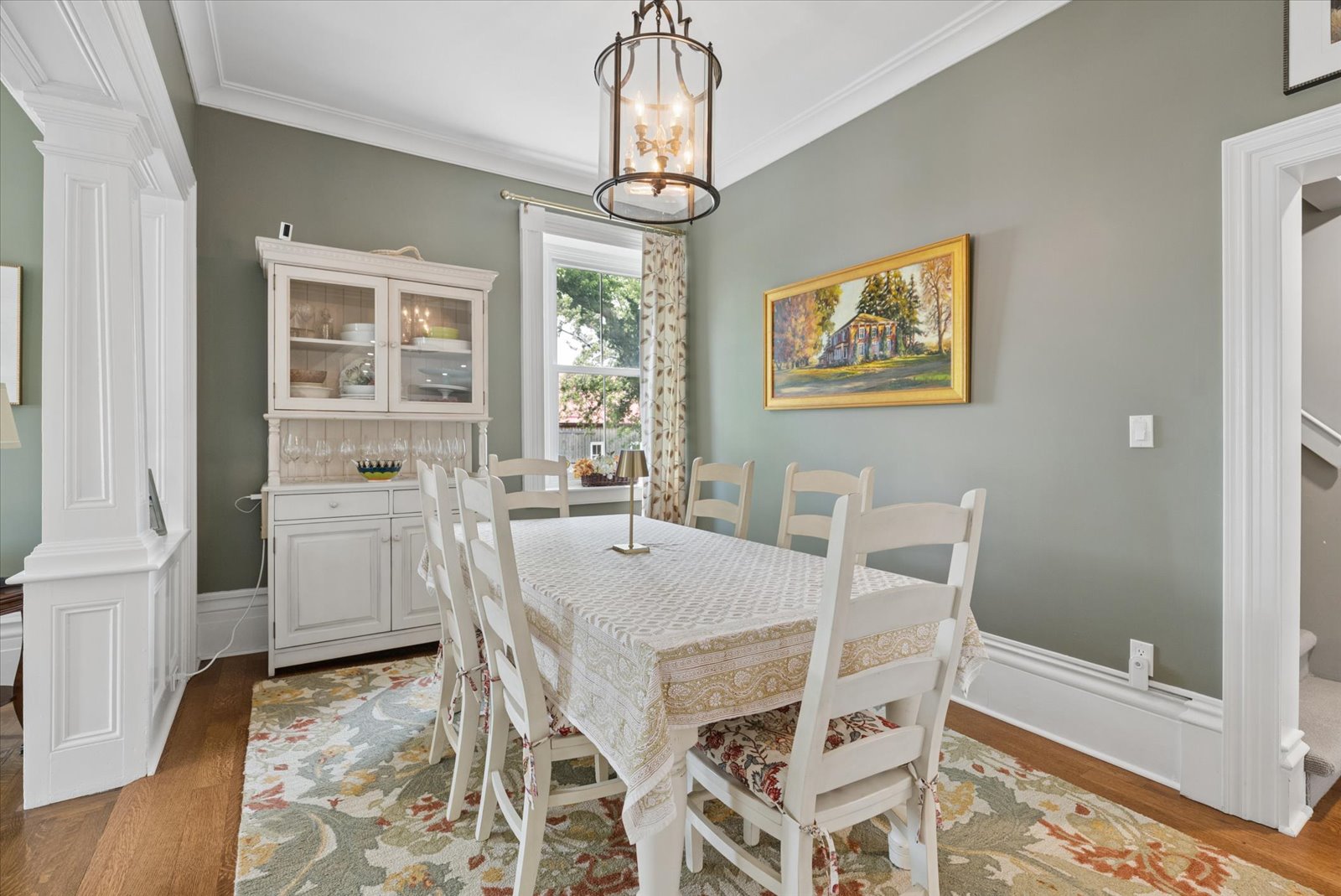 Formal dining room with lantern pendant and hutch