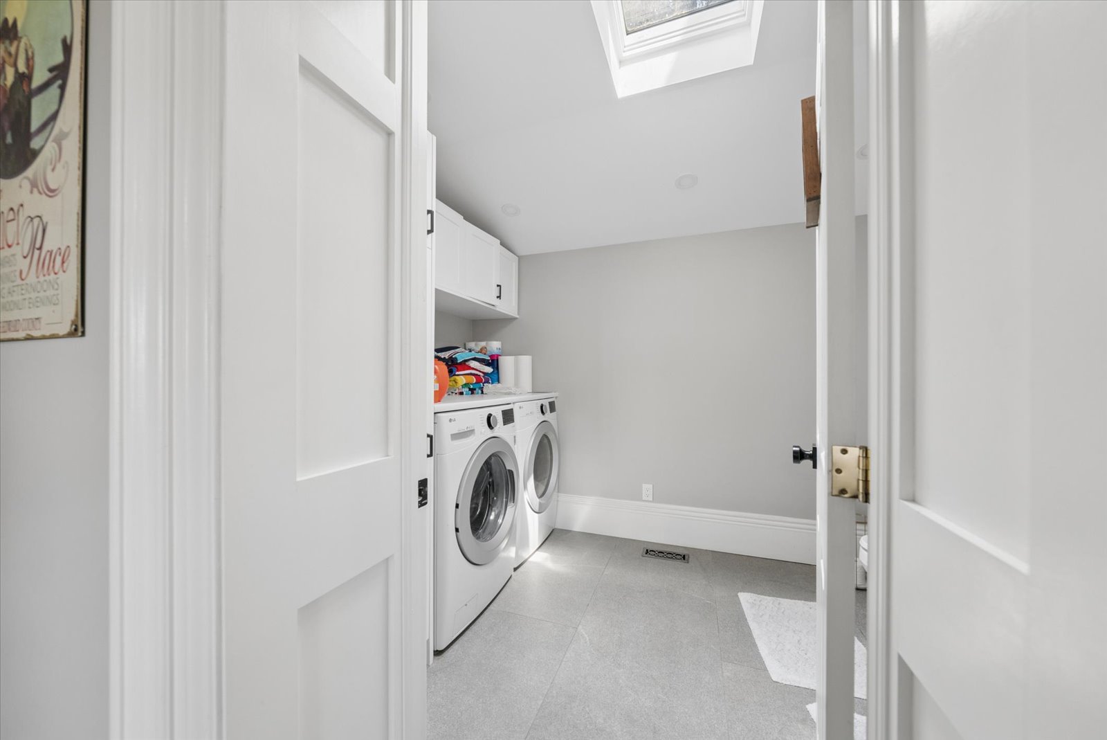 Laundry room with skylight and side-by-side machines