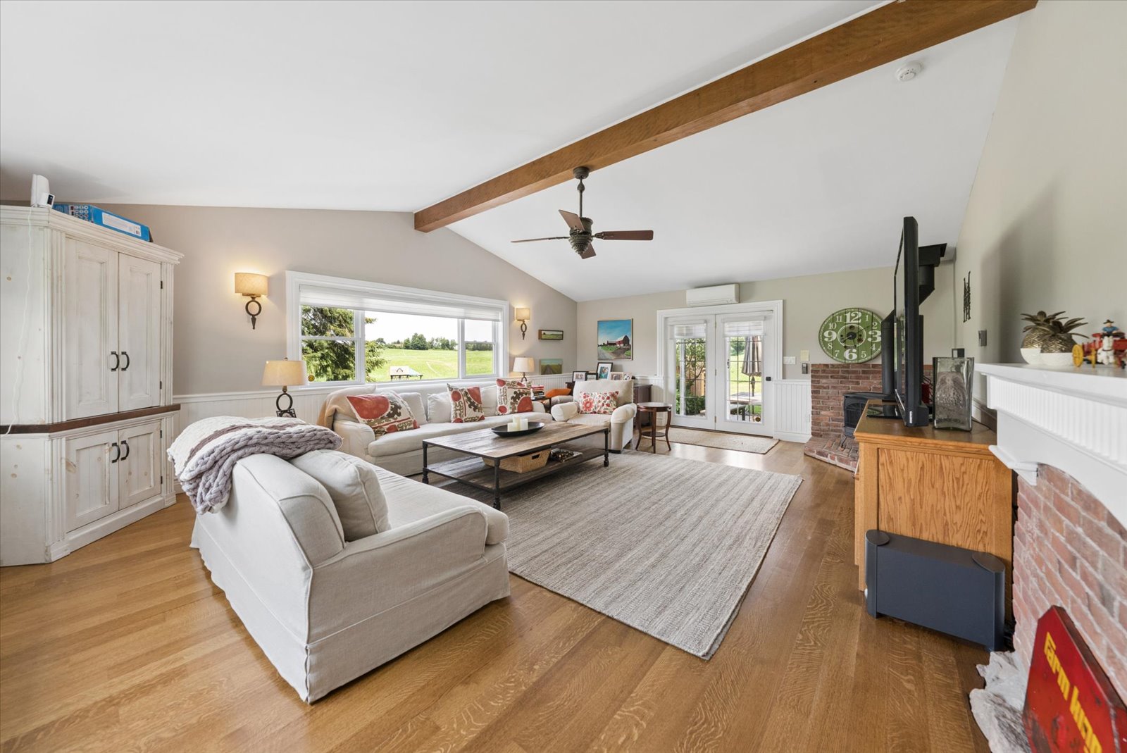 Family room with vaulted beamed ceiling and field views