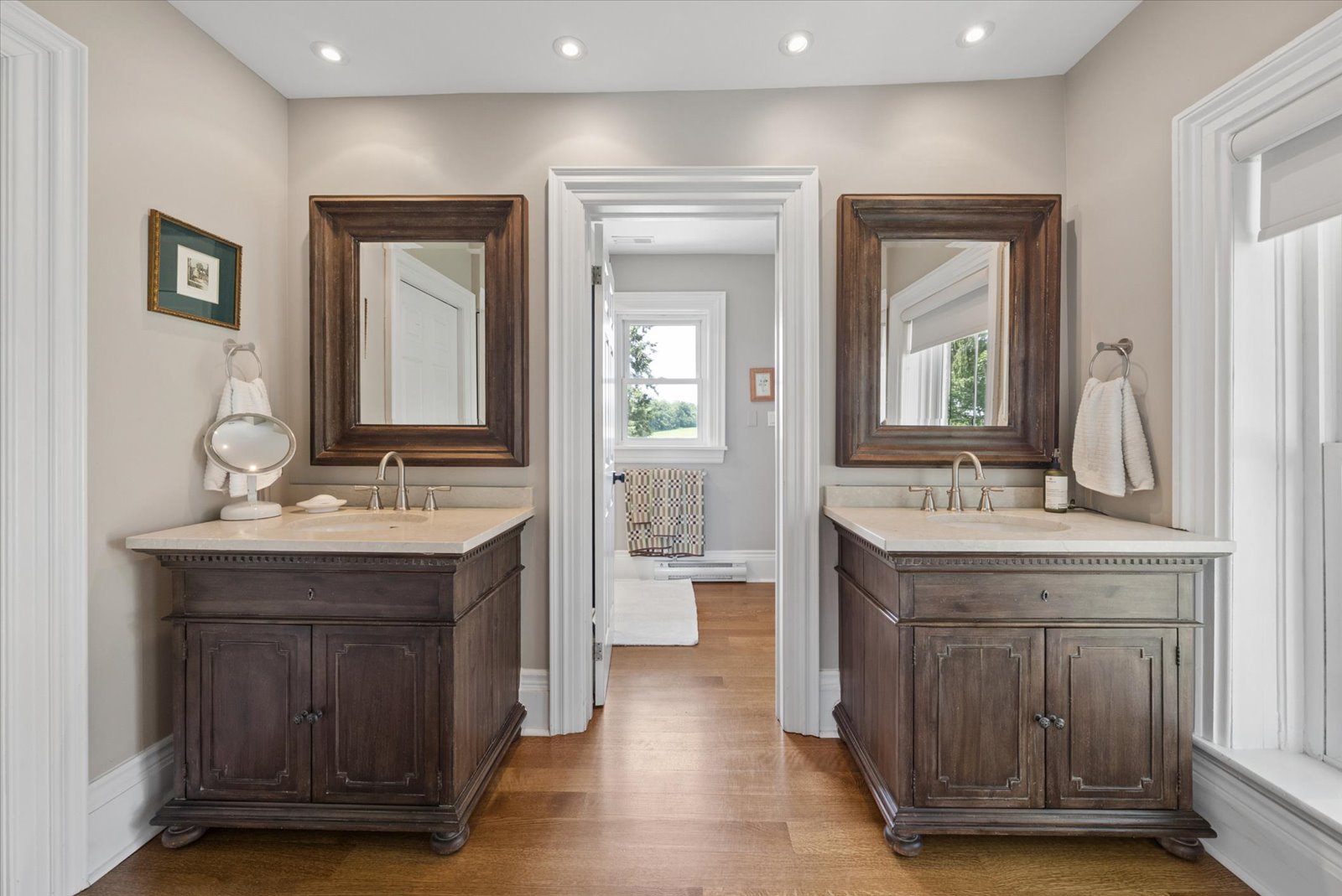 Ensuite with twin antique-style vanities and framed mirrors